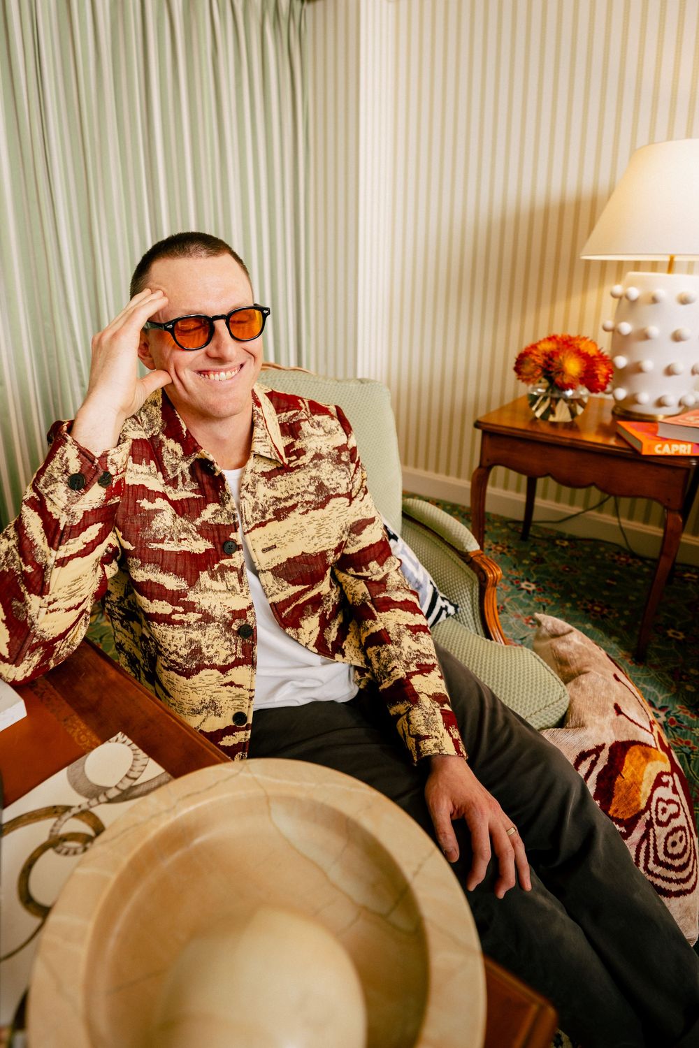 A sequence of images showing someone wearing a patterned brown shirt reclining and lounging in a chair.