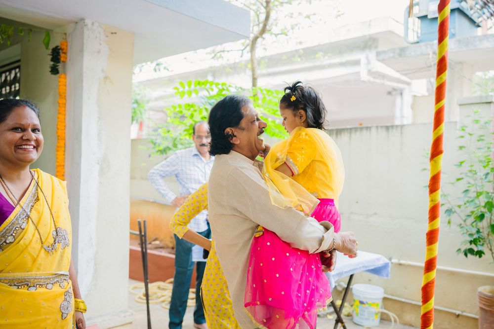 Joyful family celebration outdoors with traditional Indian clothing and decorations.