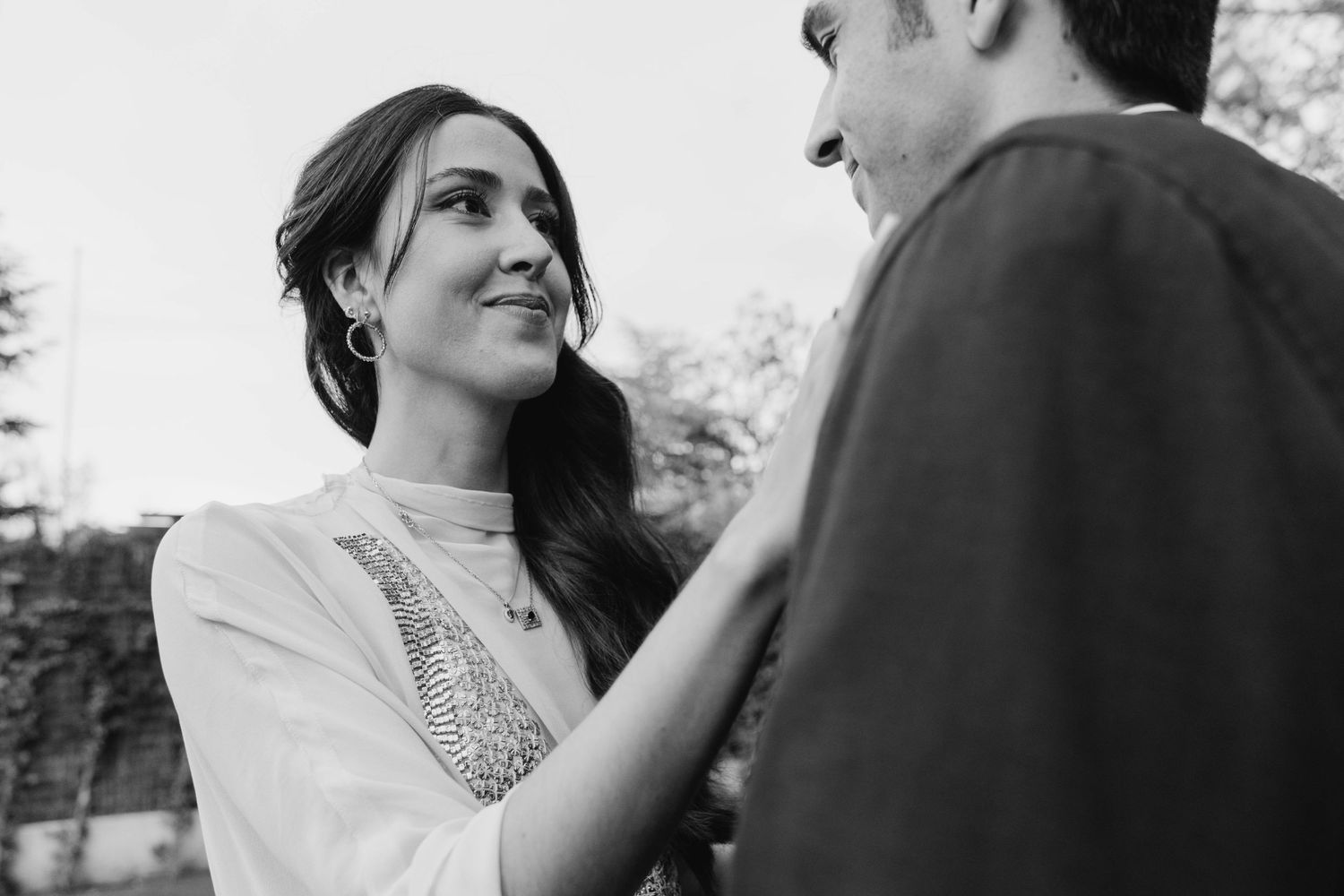 A tender black and white moment shared between two people outdoors.