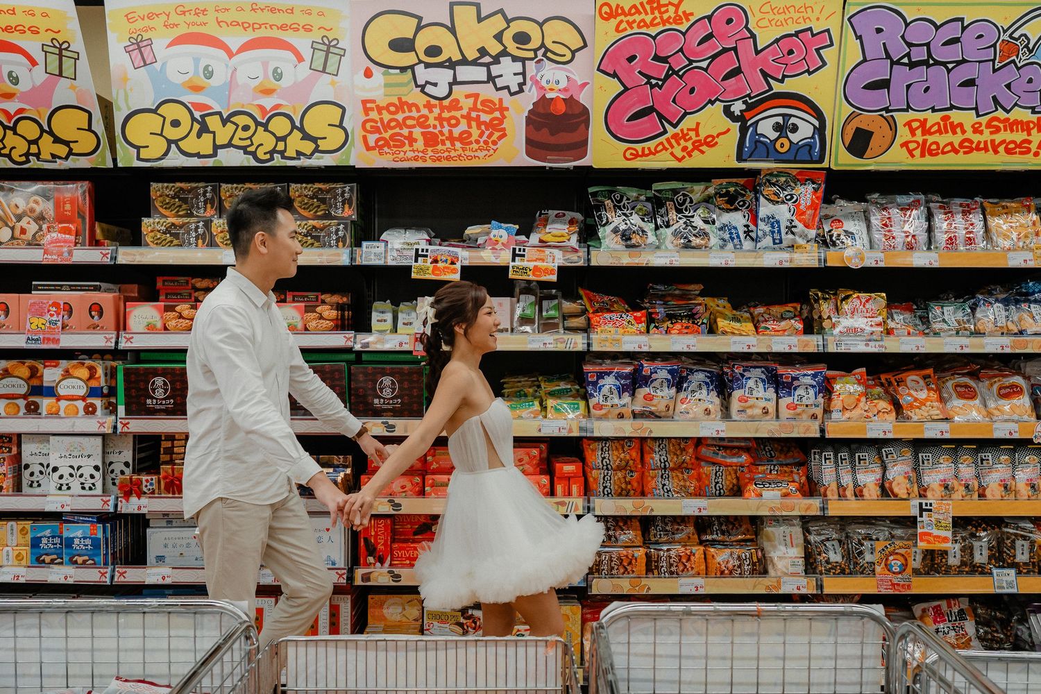 Couple having fun while shopping in a snack aisle with vibrant displays.