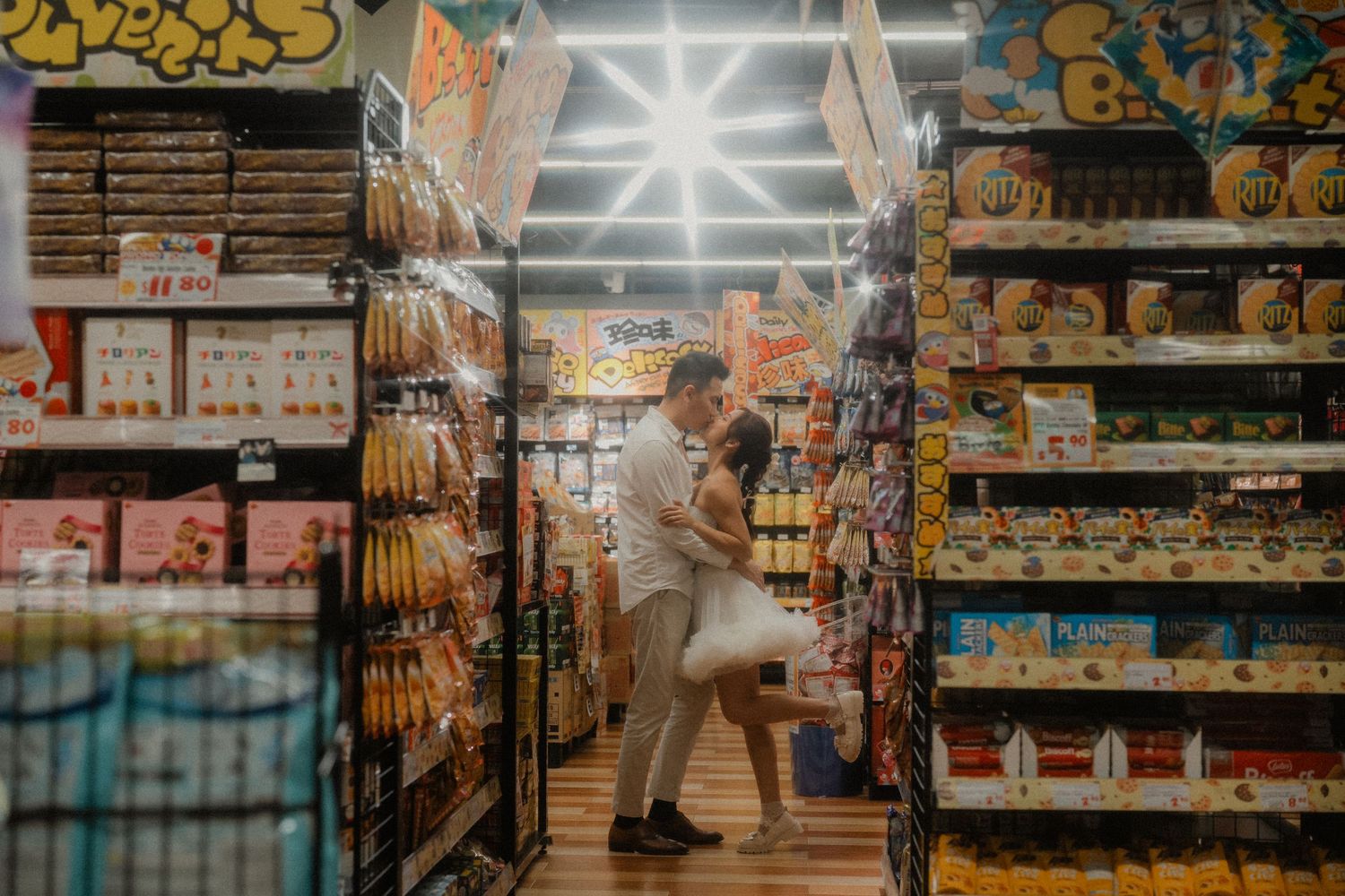 A romantic moment captured between store aisles filled with snacks and treats.