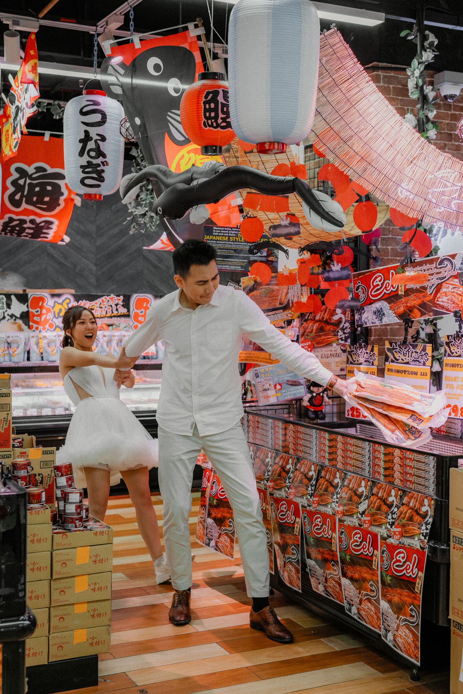 Playful dance scene captured in grocery store aisle with vibrant Japanese snack packaging.