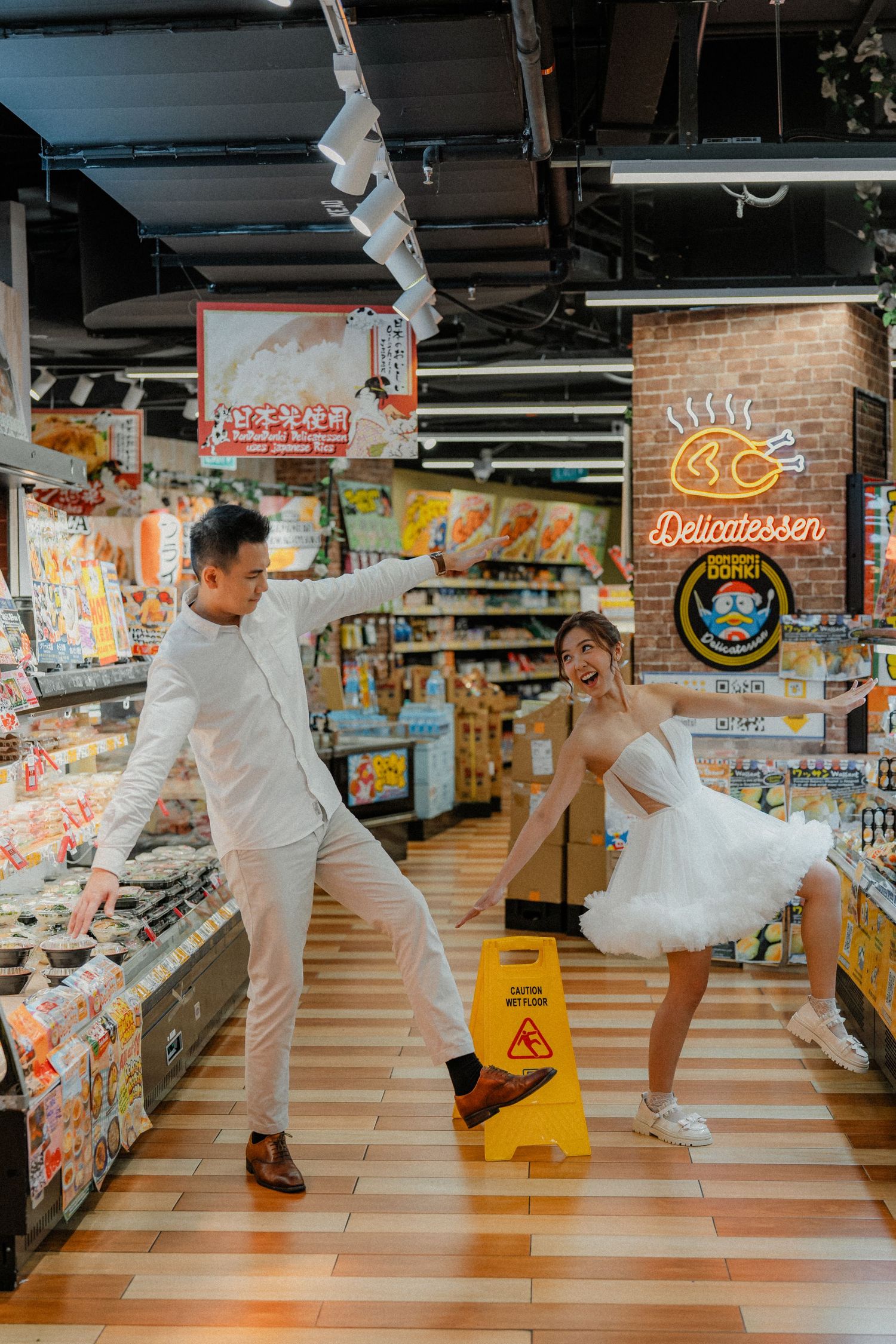 Dancing sequence in supermarket snack aisle with white outfits and colorful store displays.