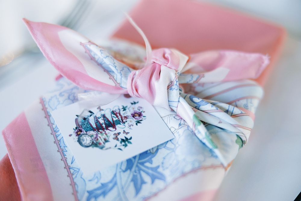 Close-up view of pink napkin with blue floral design detail.