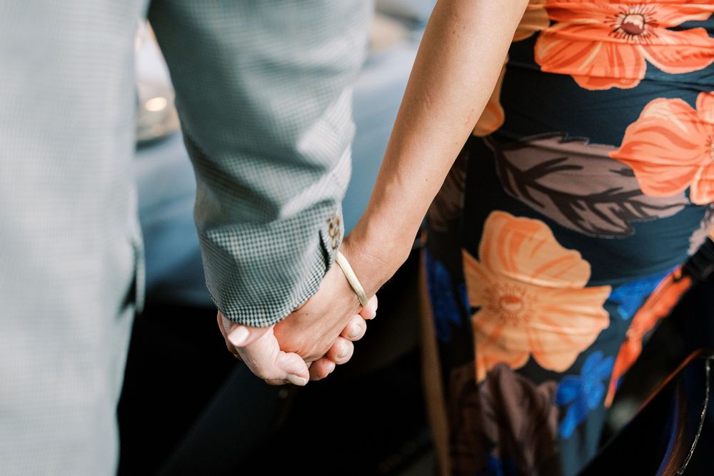People wearing casual attire stand together during a social event.