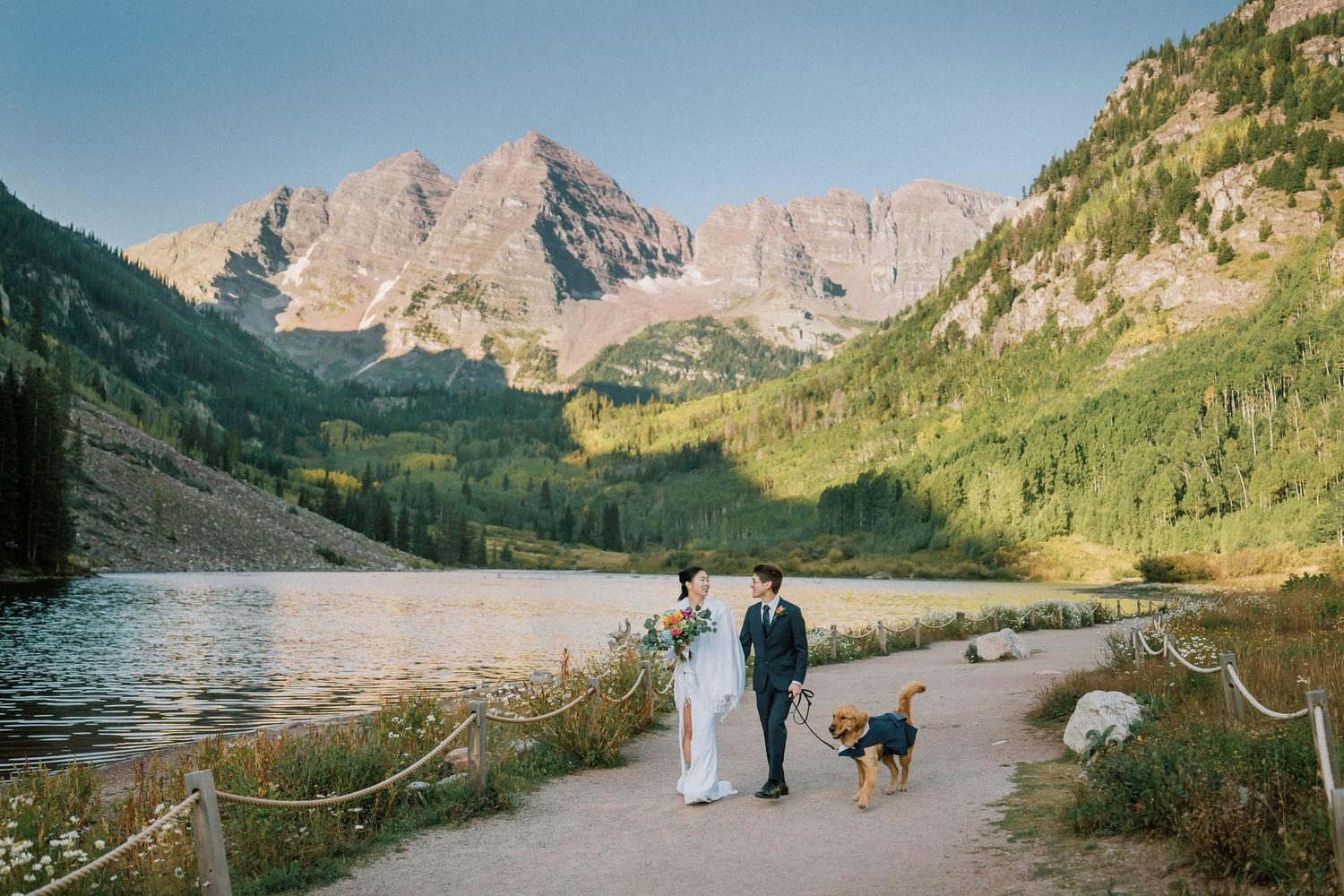 A romantic couple embraces in a scenic mountain meadow at Maroon Bells, Colorado. Elopement photography at Maroon Bells, Aspen.