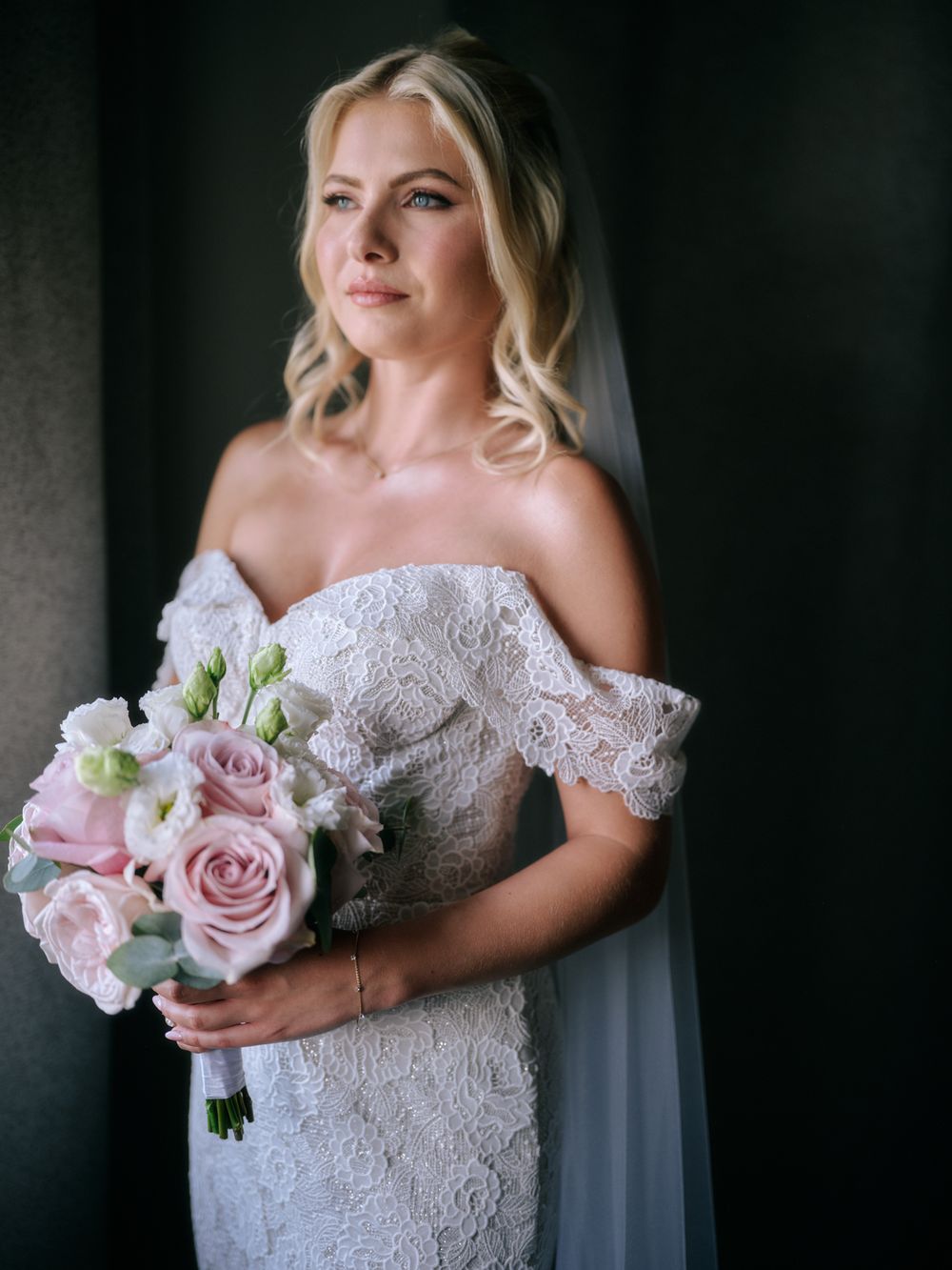 Elegant bridal portrait featuring a lace off-shoulder gown and pink rose bouquet. Photoshoot by Venice Photographer Alina Indi