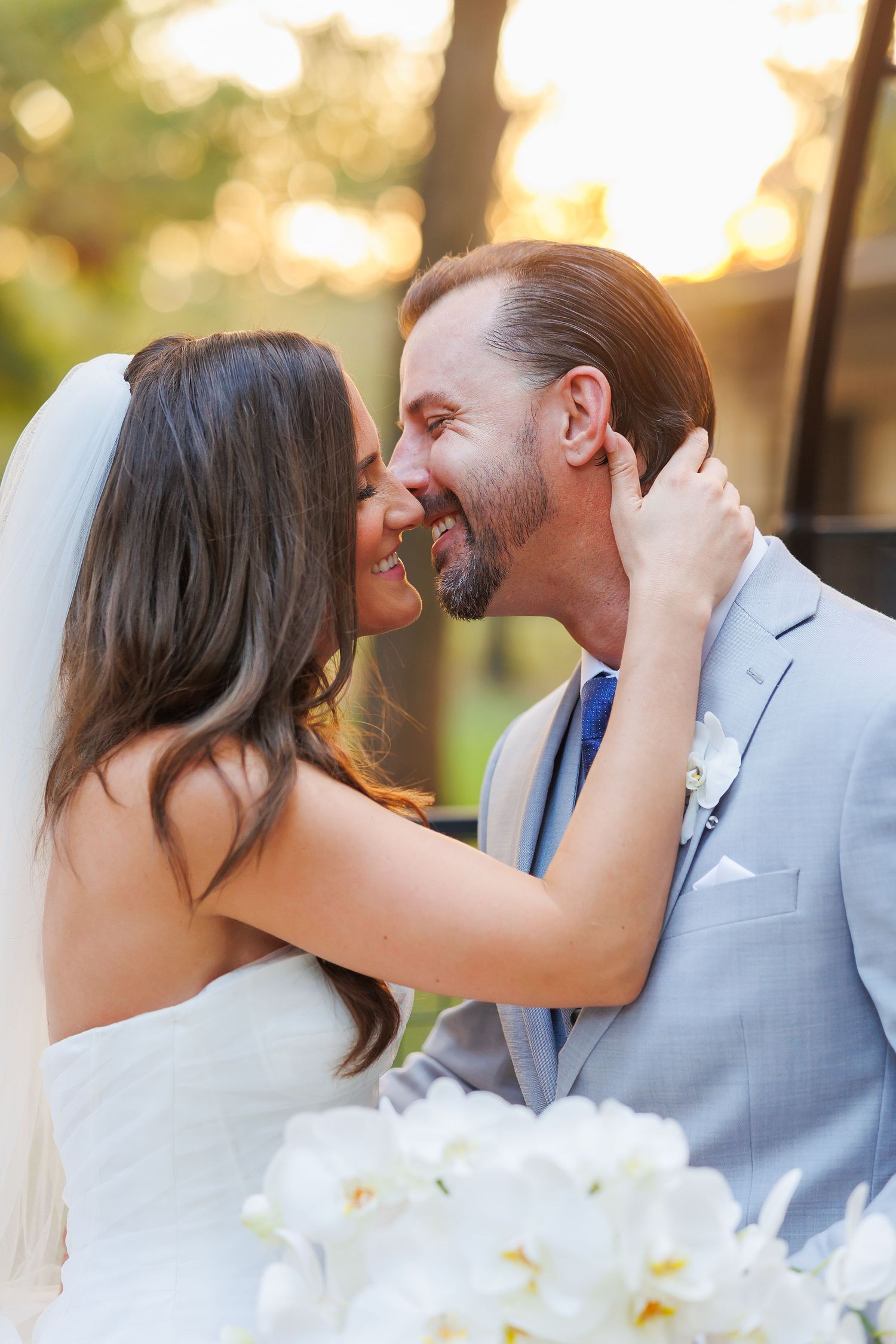 A romantic wedding kiss sequence captured at sunset with soft bokeh lighting in the background at Bella Cavalli