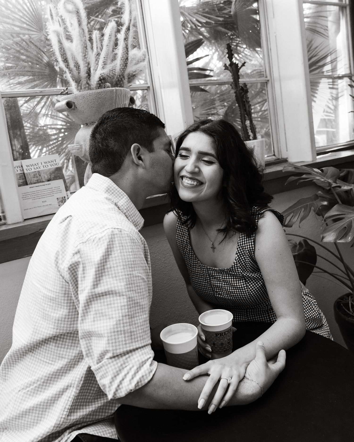 A couple on a coffee date in Press Coffee Broadway in San Antonio for a photoshoot with Caballero Creates.