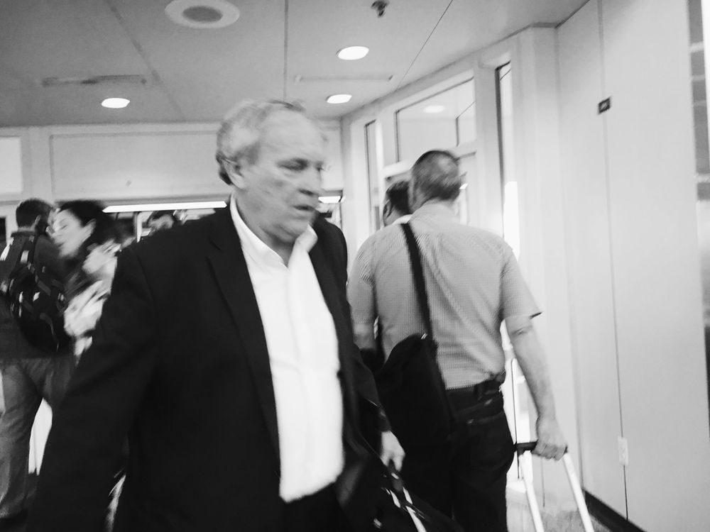 People walking through a hallway in an office building.
