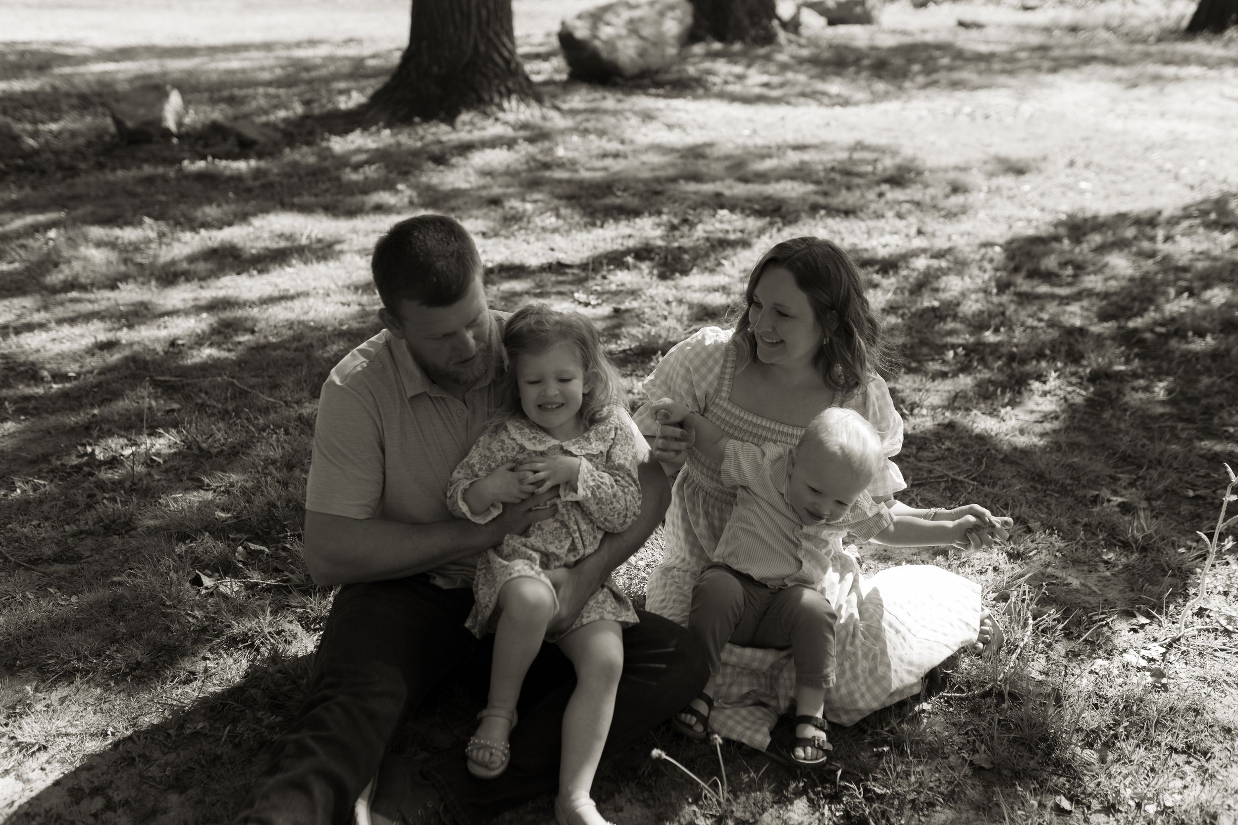 Family spending quality time together under tree shade.