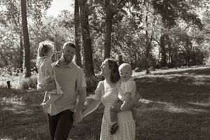 Black and white family photographs captured in sequence showing loving interactions outdoors.