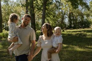 Natural lifestyle family photography session in a serene outdoor woodland setting.