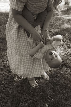 Close-up shots of playful family moments in black and white photography.