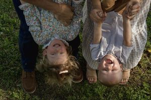 Overhead view of a family lying on grass during an outdoor photo session.
