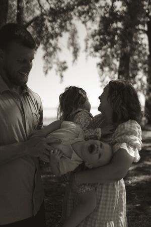 Black and white series of a family sharing intimate moments outdoors.