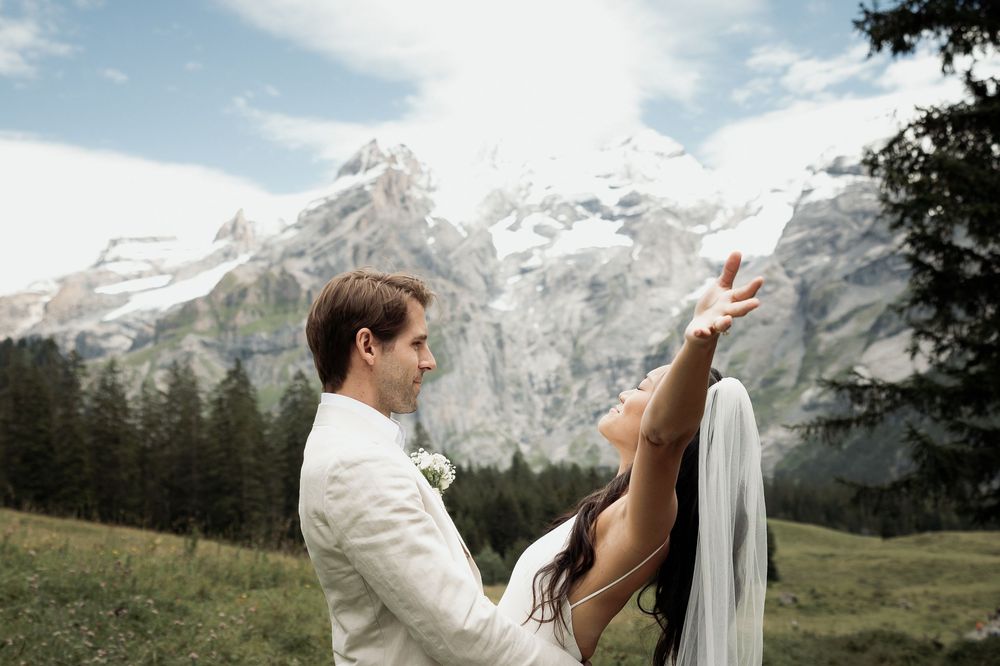 A romantic wedding photoshoot sequence with mountain scenery and flowing white veil in the breeze.