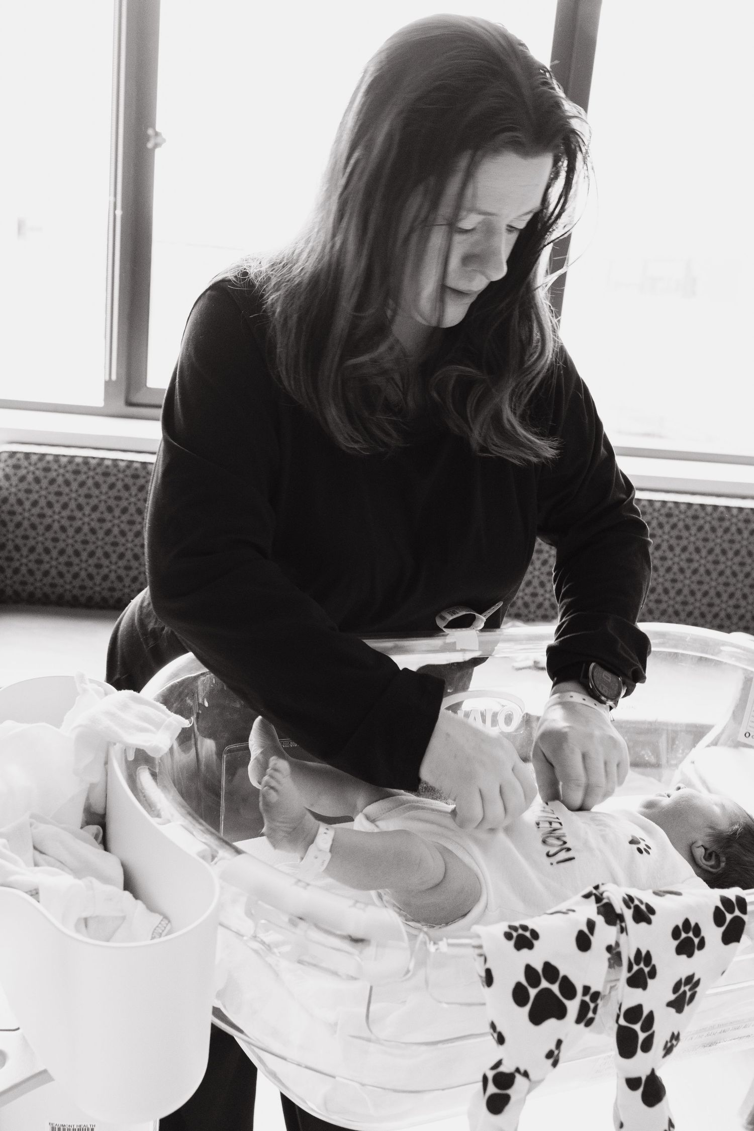 Black and white images of someone crafting with white materials and paw print patterns.