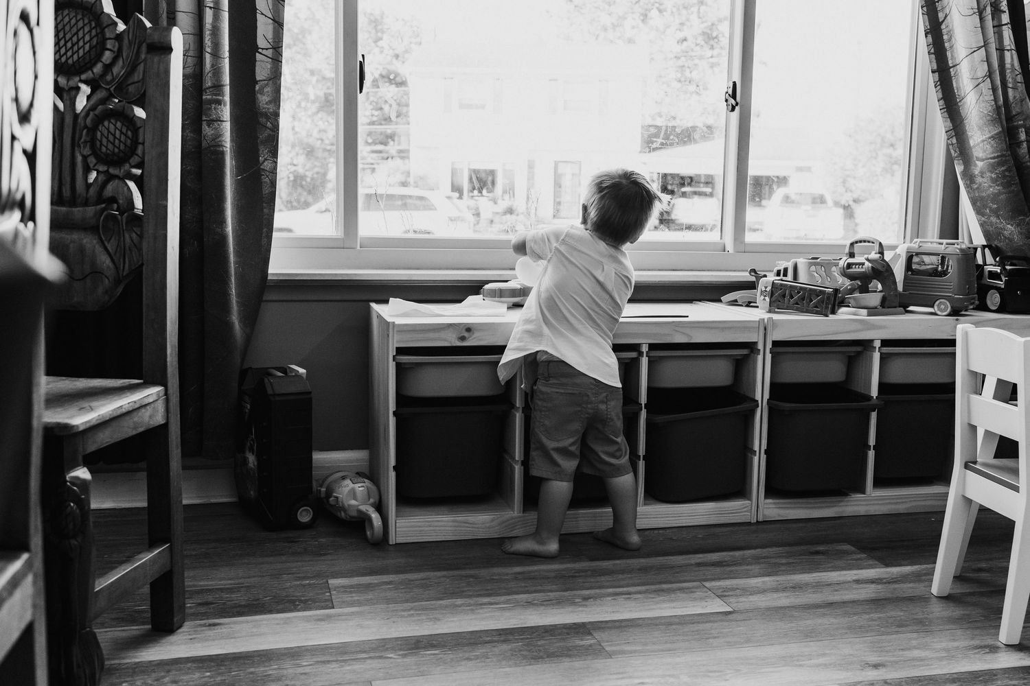 Interior view with large windows and a child at window.
