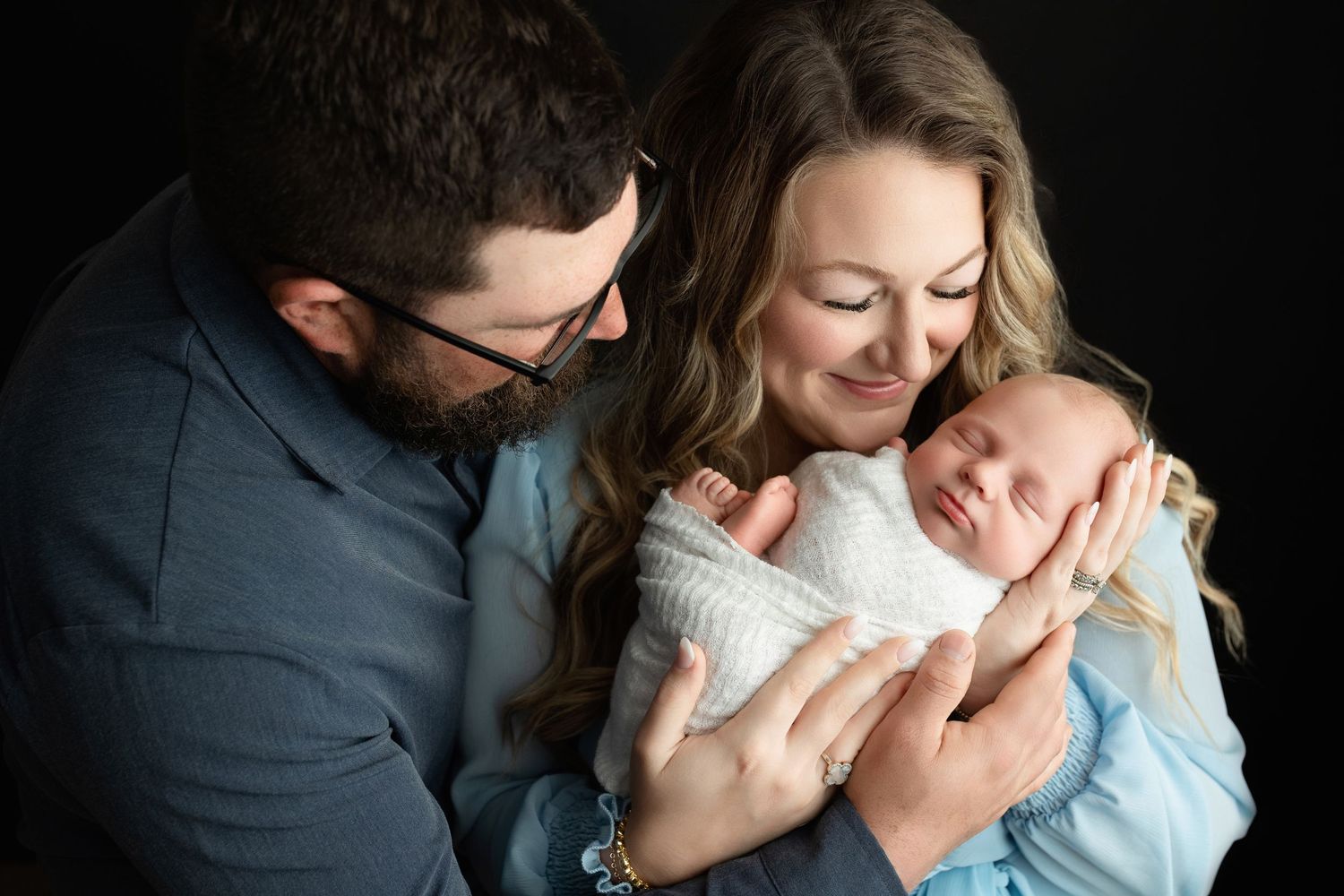 showing the connection between mom and dad snuggling their newborn baby boy. - Easley SC newborn - Greenville SC newborn