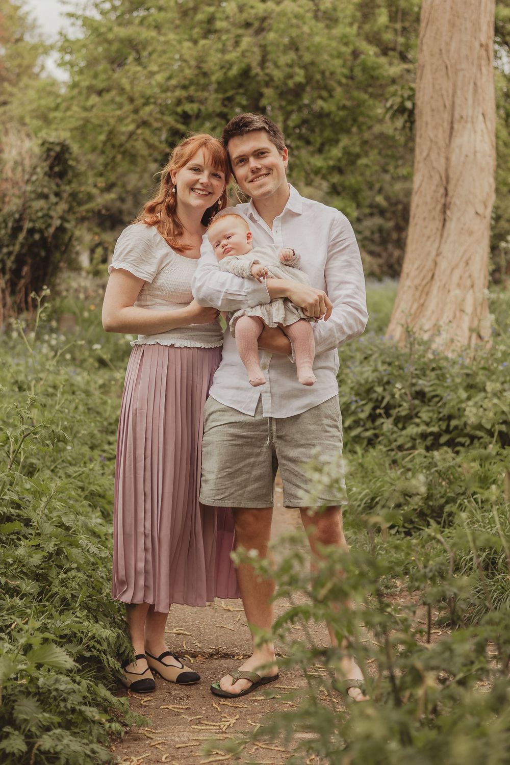 family with baby in a churchyard