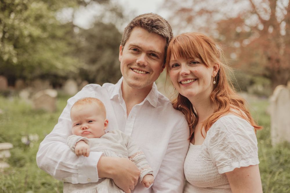 family with baby in a churchyard