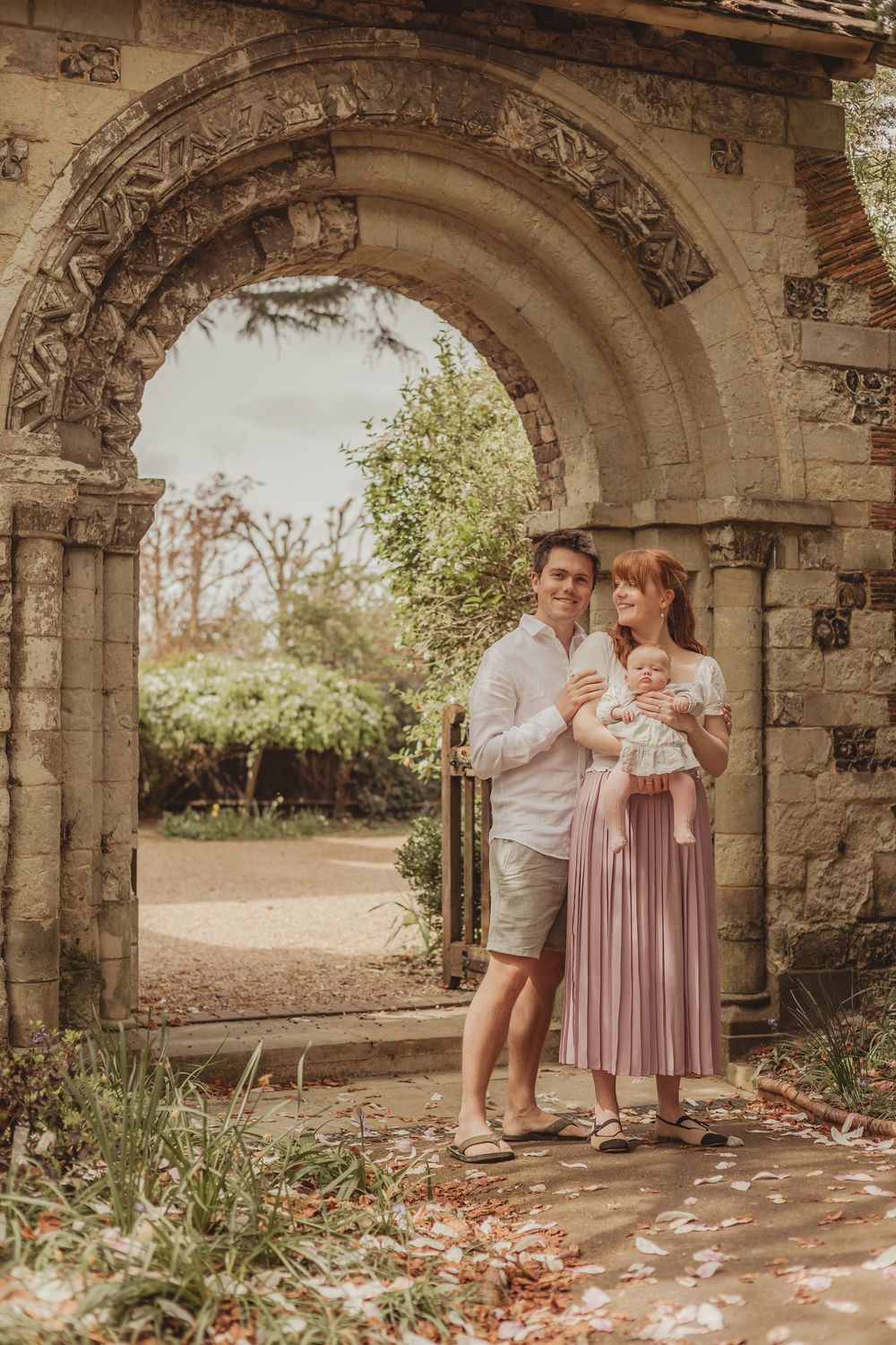 family with baby in a churchyard