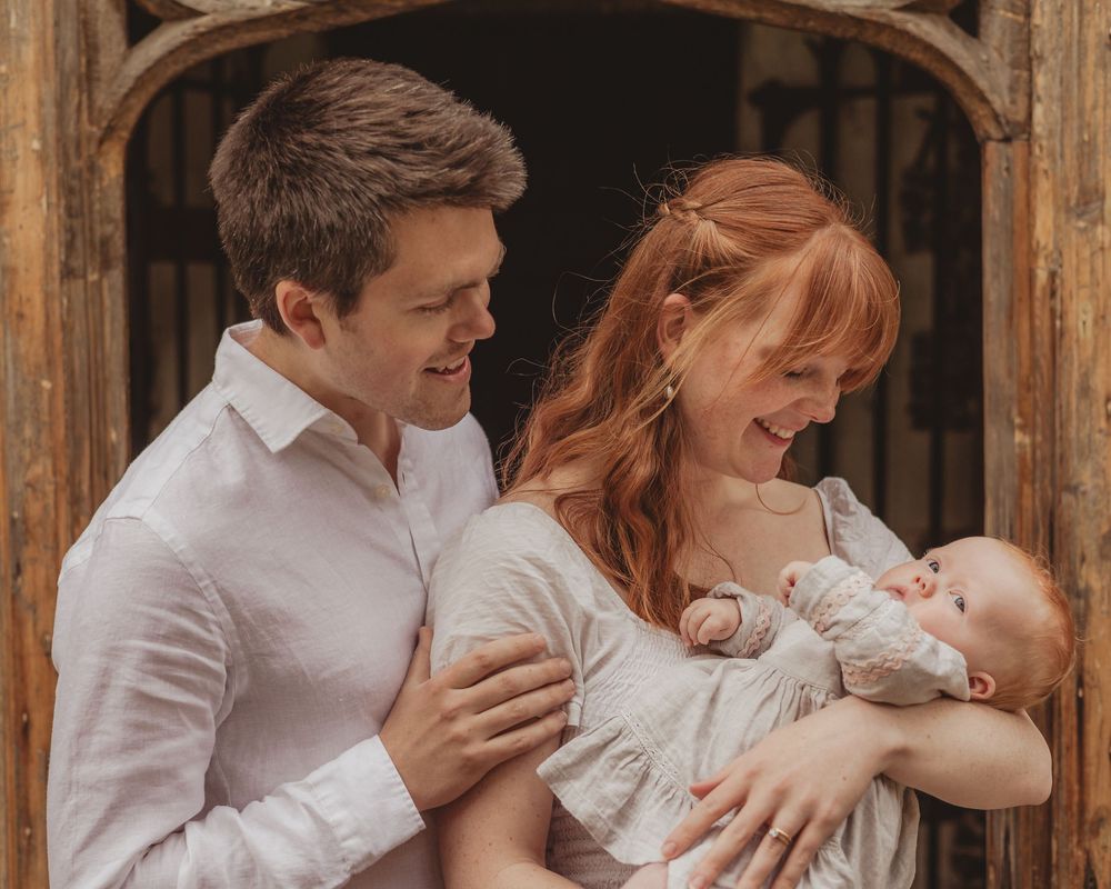 family with baby outside church