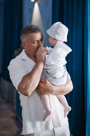 Progressive shots showing emotional moments between two people dressed in white against blue backdrop.