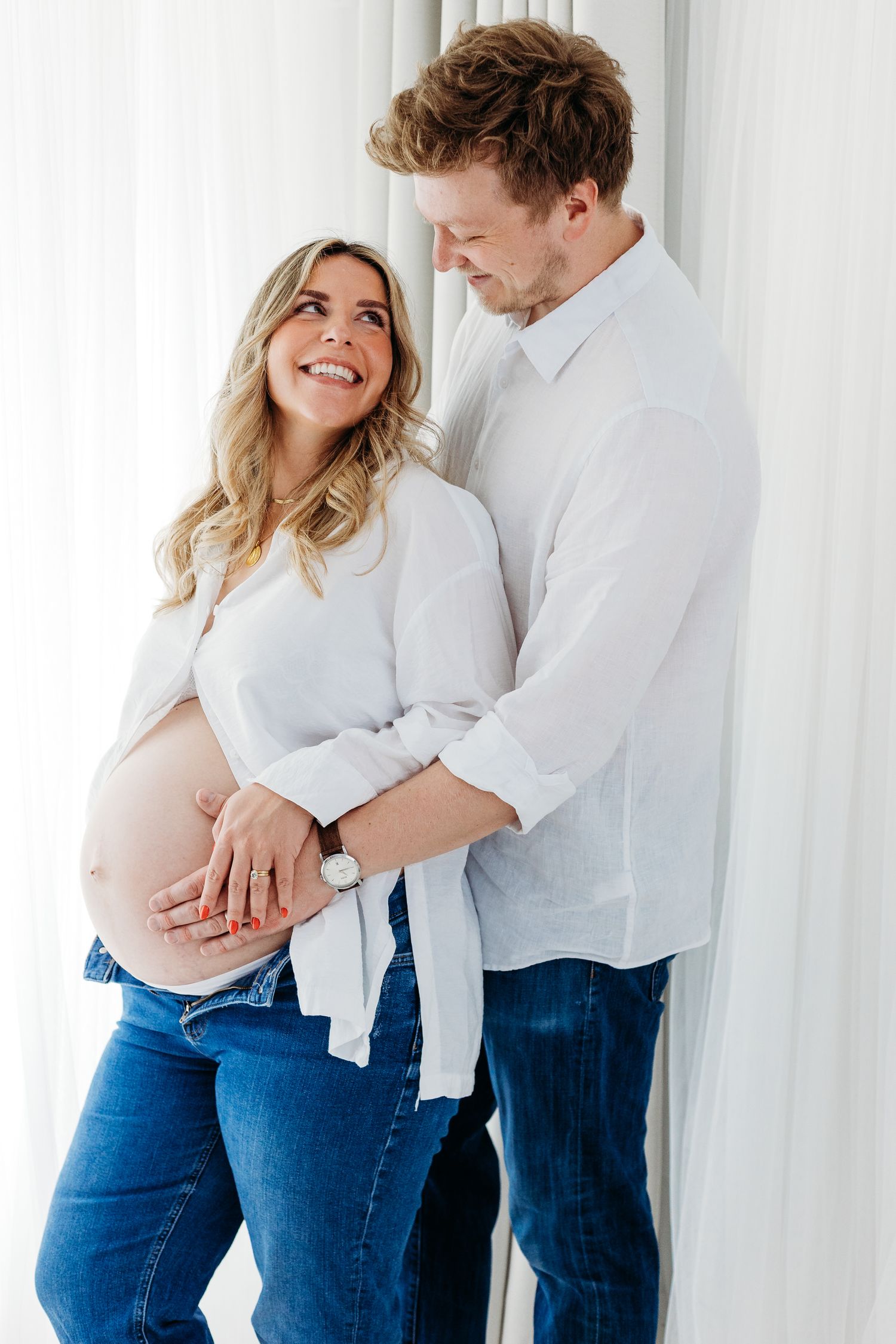 Maternity portraits in Mapperley studio, Nottingham photographer capturing glowing mum-to-be and dad to be with timeless elegance.