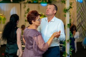 Dancing couple sharing a joyful moment on the reception dance floor.