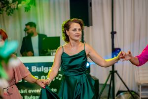 Couples dancing in formal attire at an elegant indoor venue with atmospheric lighting.