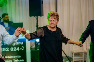 Entertainment performance at an indoor event with dramatic stage lighting effects.