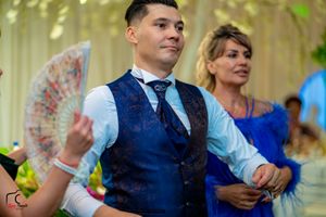 Wedding celebration with elegant decor and guests dancing under hanging lights.