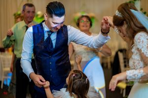 Joyful dancing moment captured during wedding reception festivities.