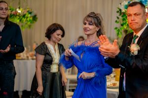 Wedding reception guests mingling and socializing at an elegantly decorated indoor venue.