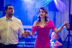 Dance floor moment captured under vibrant blue stage lighting at formal event.