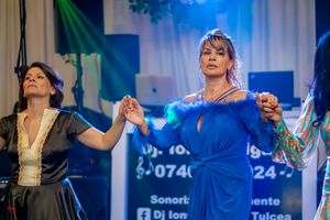 Wedding reception dance floor with colorful blue lighting and festive atmosphere.