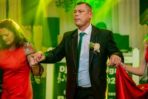 Dance partners performing coordinated moves during a ballroom dance event.