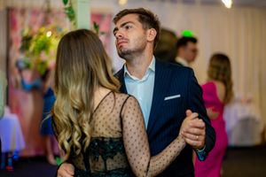 Wedding reception dance floor filled with couples enjoying a romantic slow dance.