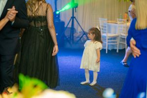 Wedding guests dancing on a blue-lit dance floor during an evening celebration.