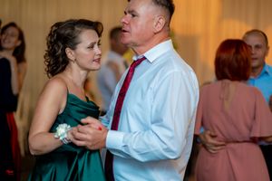 Couples dancing together at an elegant indoor wedding reception venue.