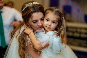 A sweet embrace captured during a wedding celebration with mixed lighting effects.