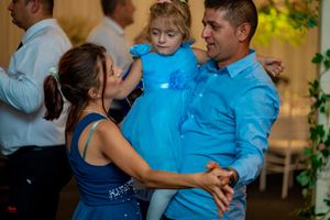 Wedding guests dancing and celebrating on the reception dance floor.