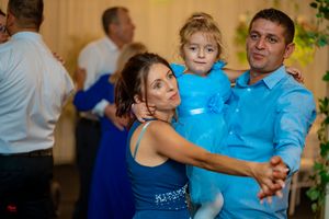 Couples sharing dances during an evening wedding reception celebration.