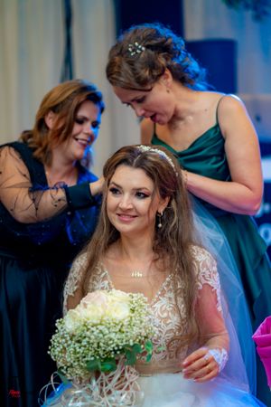 Wedding party gathering with baby's breath bouquet and elegant formal attire.