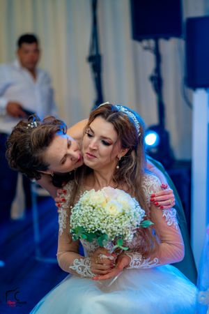 Bride in a white ballgown holding a bouquet during romantic wedding moments.