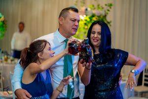 Wedding reception dance floor filled with guests in formal attire.