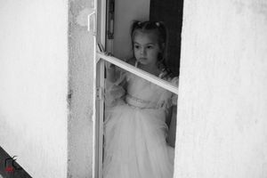 Black and white series showing wedding day preparation through doorway.
