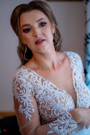 Elegant bridal portrait showcasing delicate white lace appliques on sheer fabric.